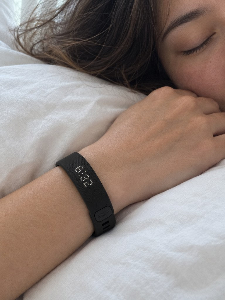 The ECDF Silent Alarm Wristband worn at night on a sleeping woman's wrist